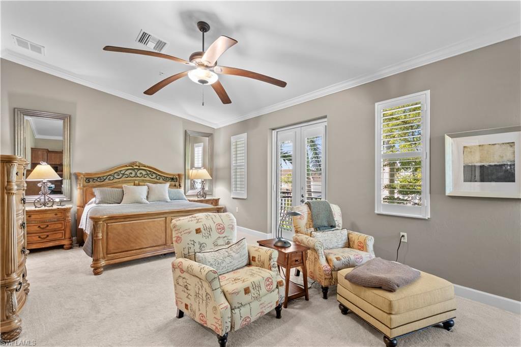 1104 6th Street South, Unit 1 Naples, FL 34102 - Photo 26 of 40 Carpeted bedroom with crown molding, ceiling fan, and access to outside