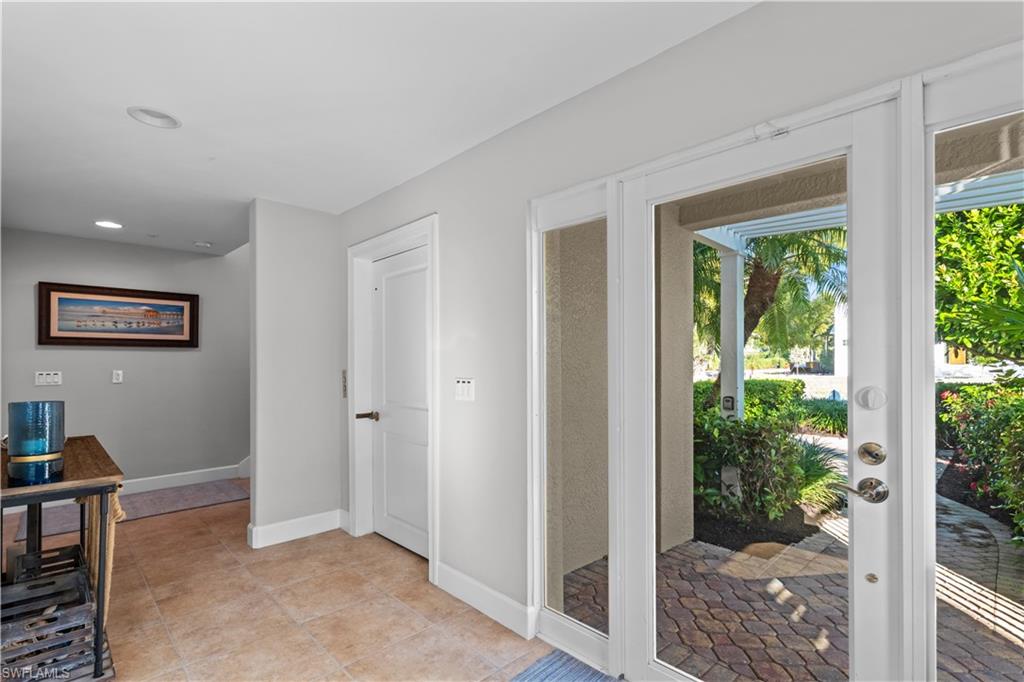 1104 6th Street South, Unit 1 Naples, FL 34102 - Photo 3 of 40 Doorway to outside with tile patterned floors and recessed lighting
