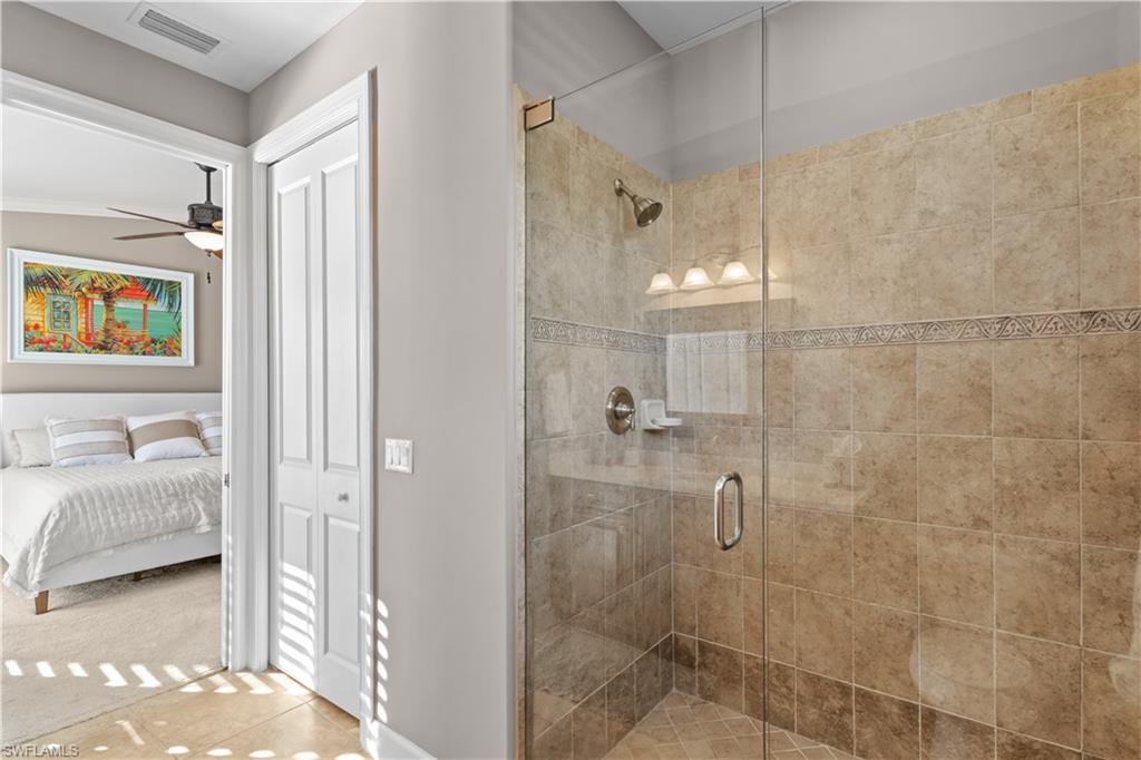 1104 6th Street South, Unit 1 Naples, FL 34102 - Photo 31 of 40 Bathroom featuring a stall shower, ensuite bath, ceiling fan, and a closet