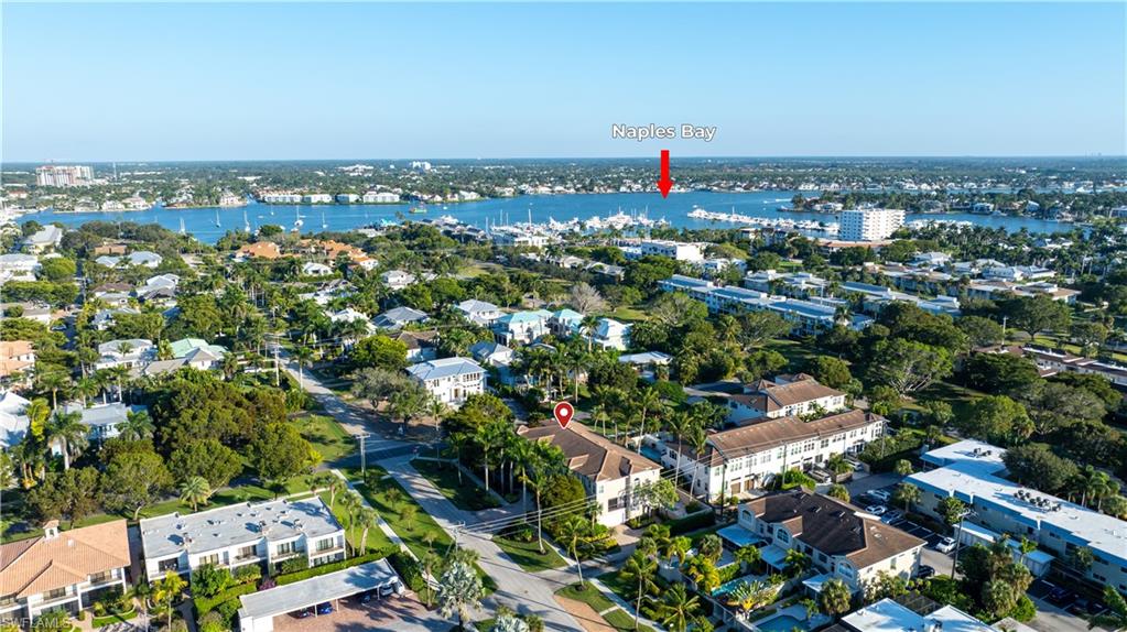 1104 6th Street South, Unit 1 Naples, FL 34102 - Photo 37 of 40 Aerial view of property and surrounding area with nearby suburban area and a large body of water