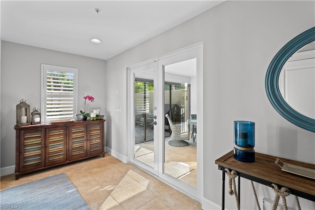 1104 6th Street South, Unit 1 Naples, FL 34102 - Photo 4 of 40 Doorway to outside featuring plenty of natural light, recessed lighting, and tile patterned floors