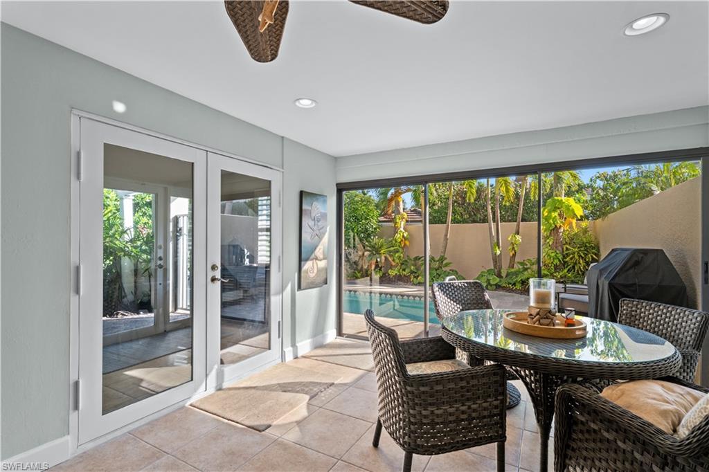 1104 6th Street South, Unit 1 Naples, FL 34102 - Photo 5 of 40 Sunroom / solarium featuring french doors and recessed lighting
