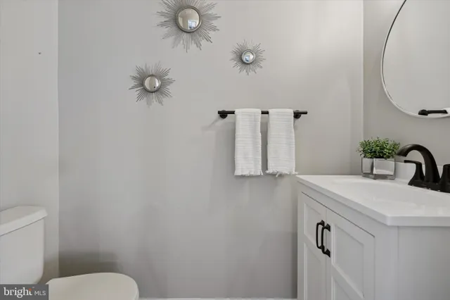 a bathroom with a sink a toilet and a mirror