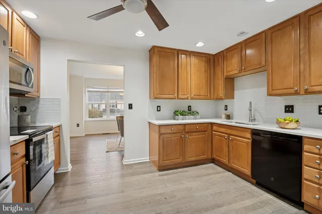 a kitchen with stainless steel appliances granite countertop a stove a sink dishwasher and a refrigerator
