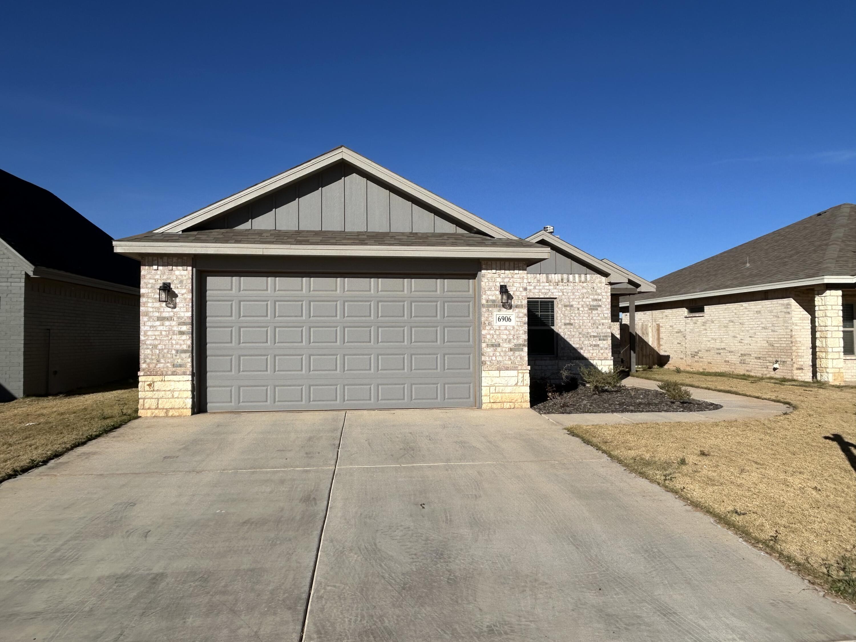 6906 18th Street Lubbock, TX 79416 - Photo 2 of 14 a front view of a house with a garage