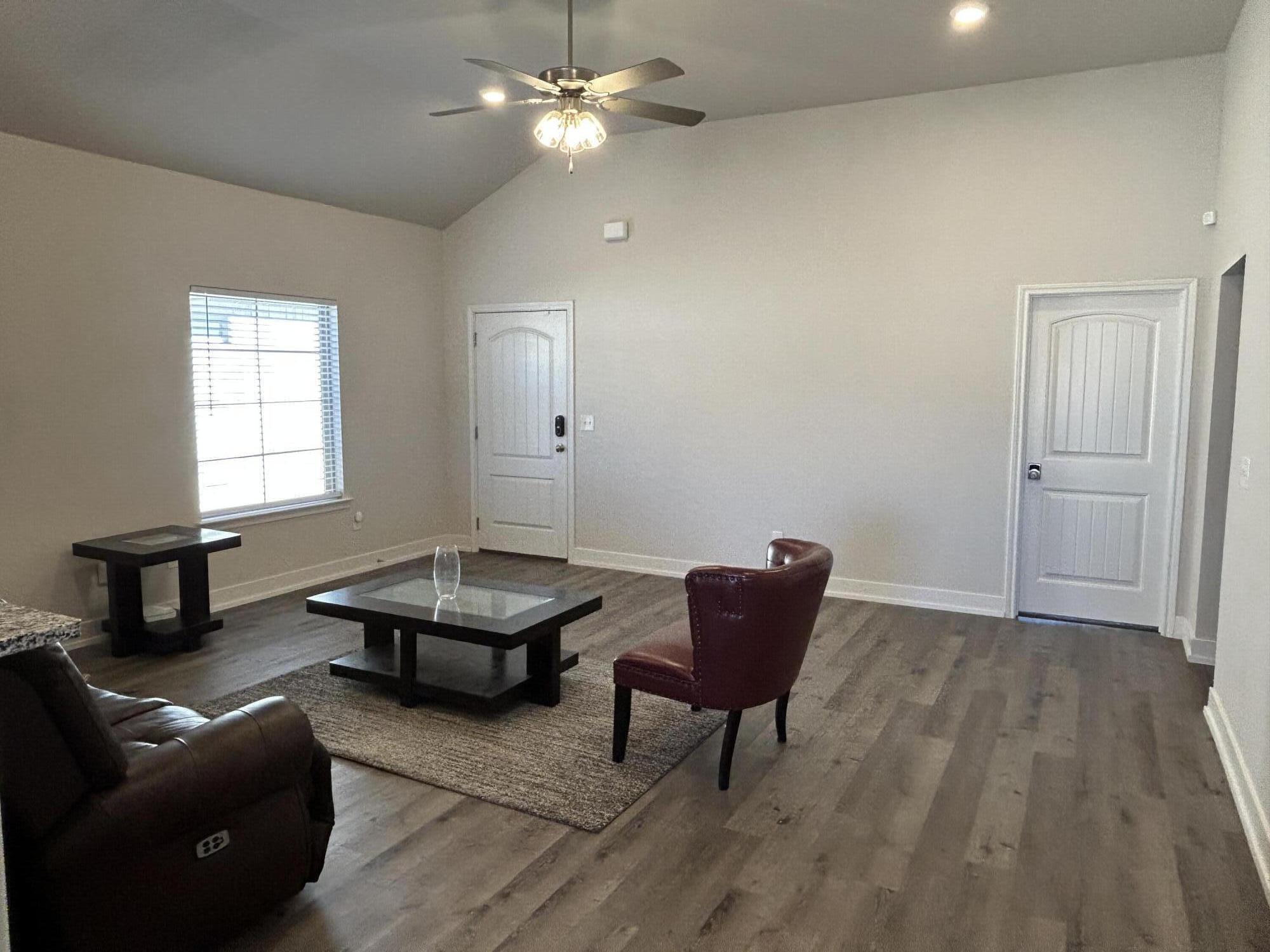 6906 18th Street Lubbock, TX 79416 - Photo 3 of 14 a living room with furniture and a wooden floor