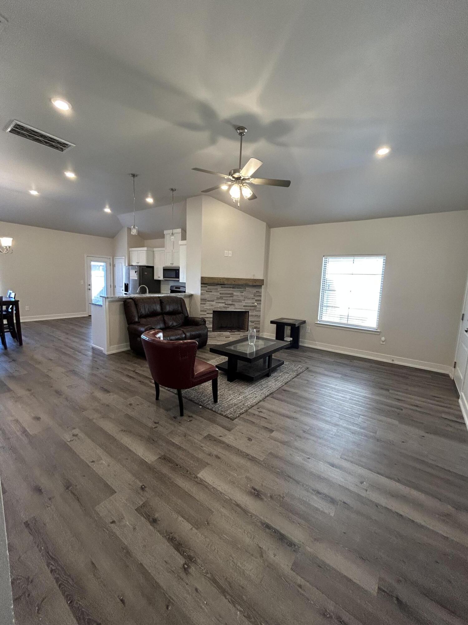 6906 18th Street Lubbock, TX 79416 - Photo 4 of 14 a living room with furniture and a large window