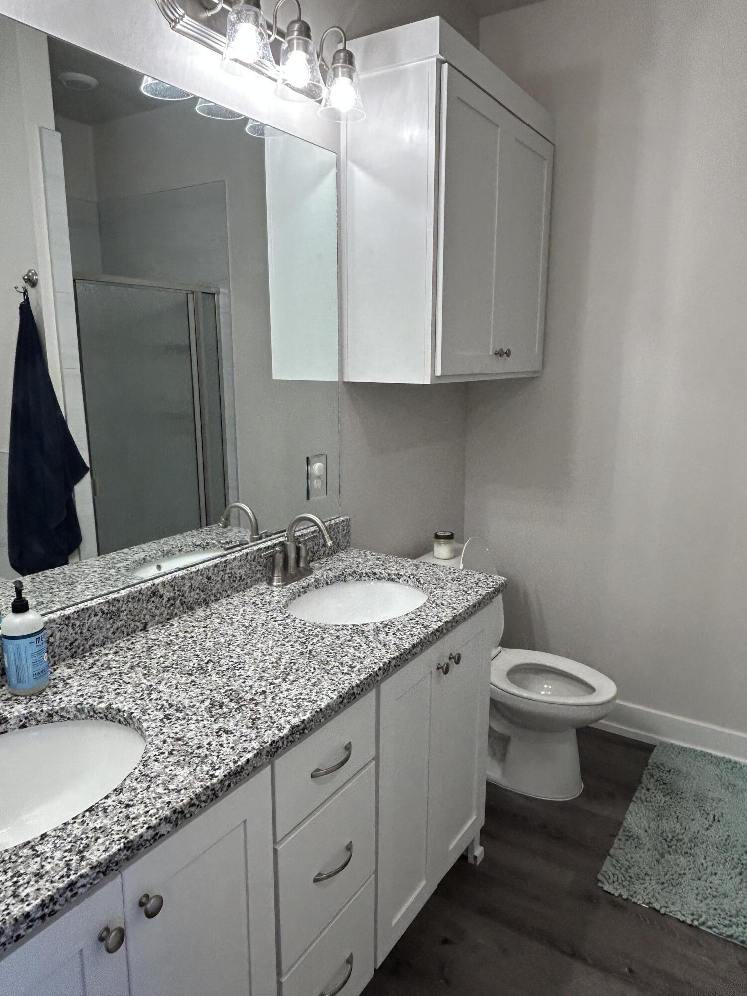 6906 18th Street Lubbock, TX 79416 - Photo 8 of 14 a bathroom with a granite countertop sink and a mirror