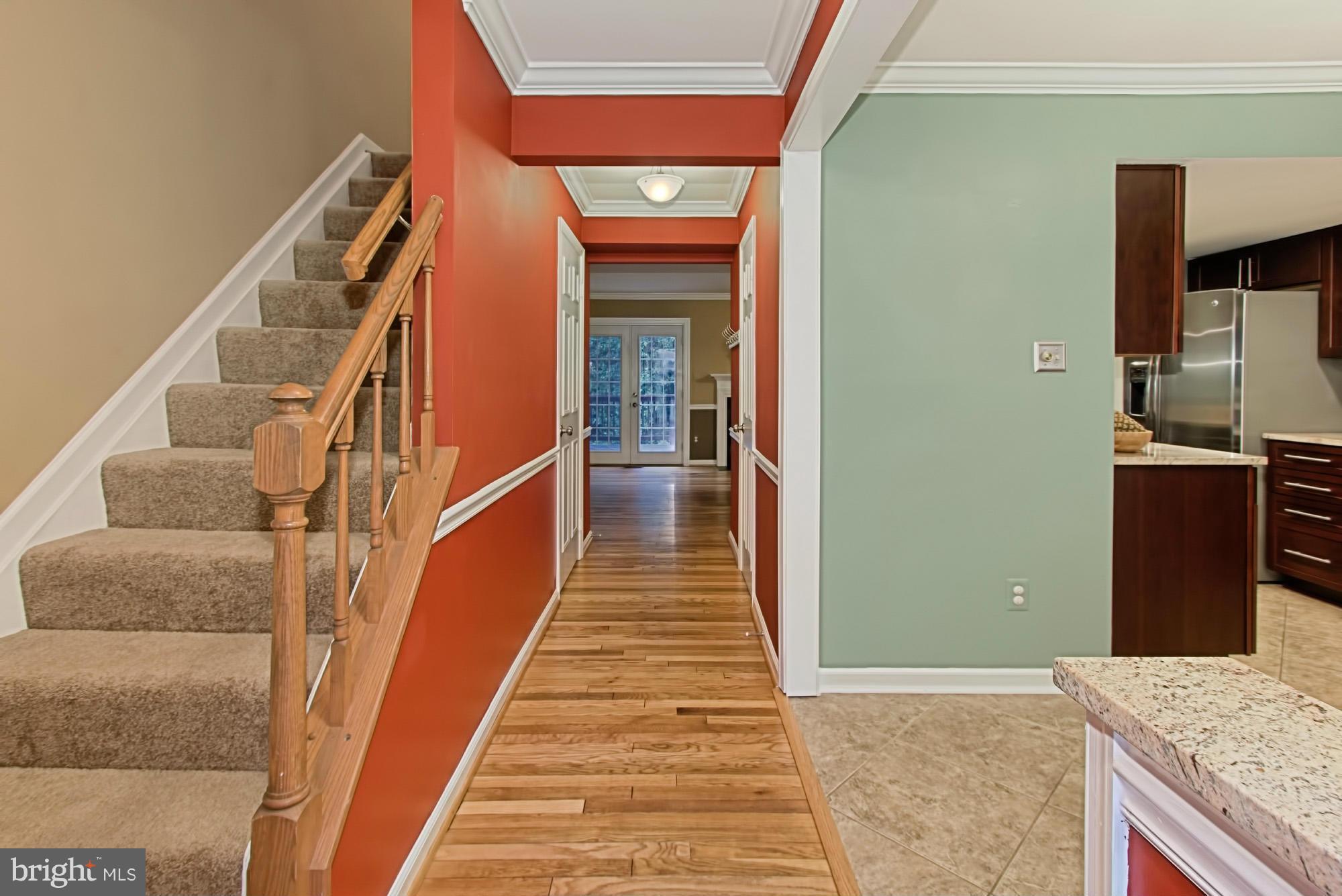 6271 Rathlin Drive Springfield, VA 22152 - Photo 2 of 29 a view of a hallway with wooden floor and staircase