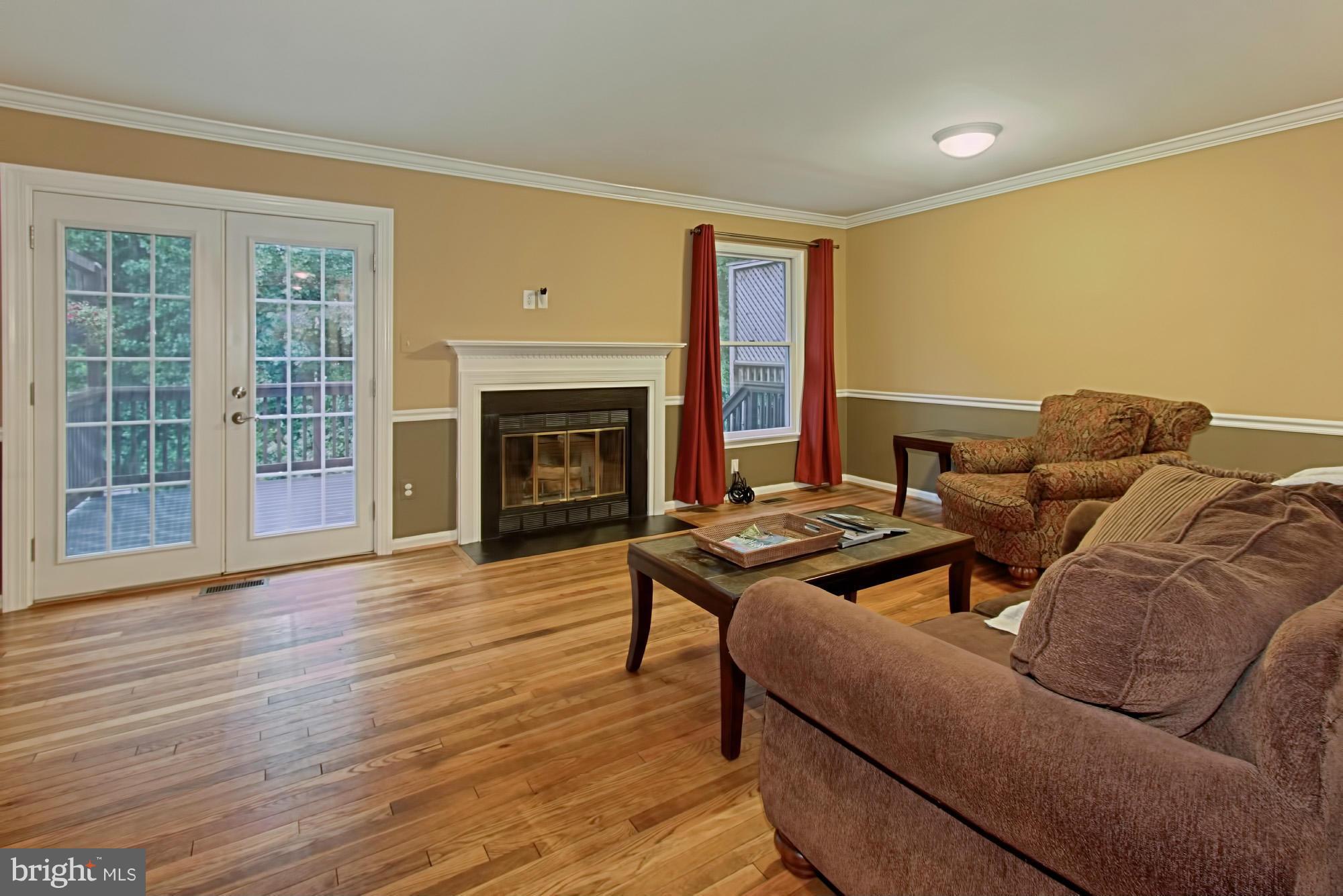 6271 Rathlin Drive Springfield, VA 22152 - Photo 11 of 29 a living room with furniture and a fireplace