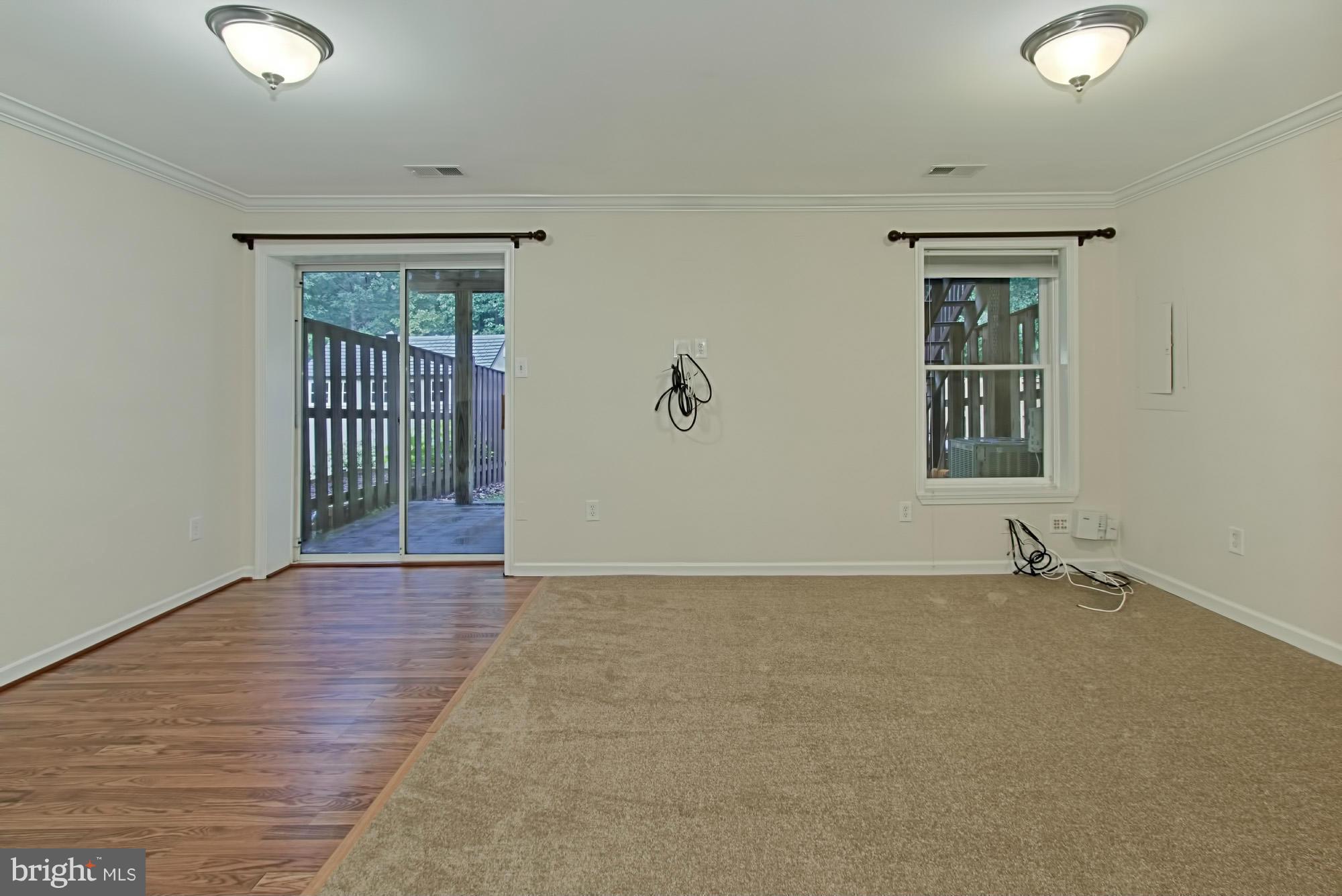6271 Rathlin Drive Springfield, VA 22152 - Photo 23 of 29 an empty room with wooden floor and windows