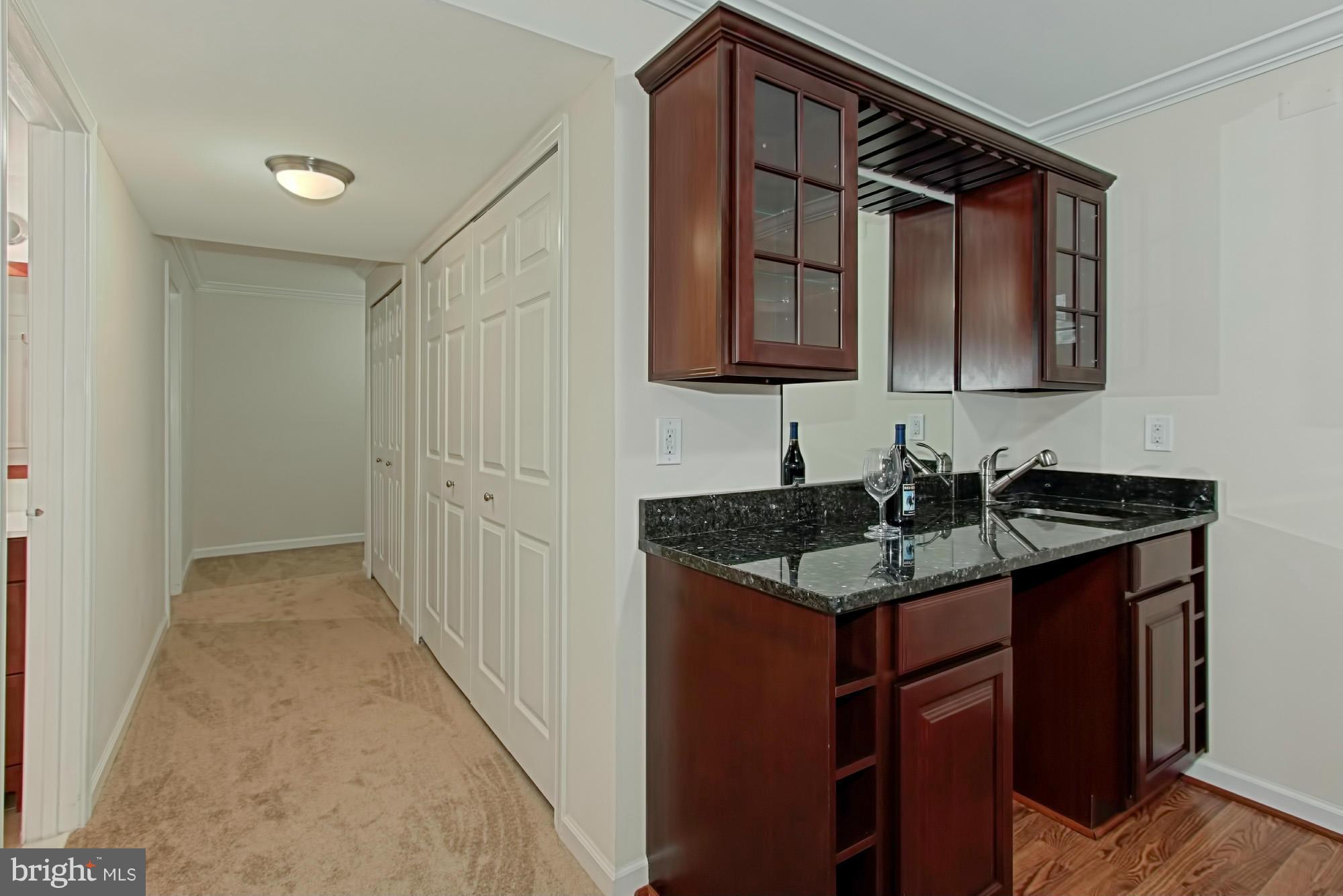 6271 Rathlin Drive Springfield, VA 22152 - Photo 24 of 29 a bathroom with a granite countertop sink and a mirror