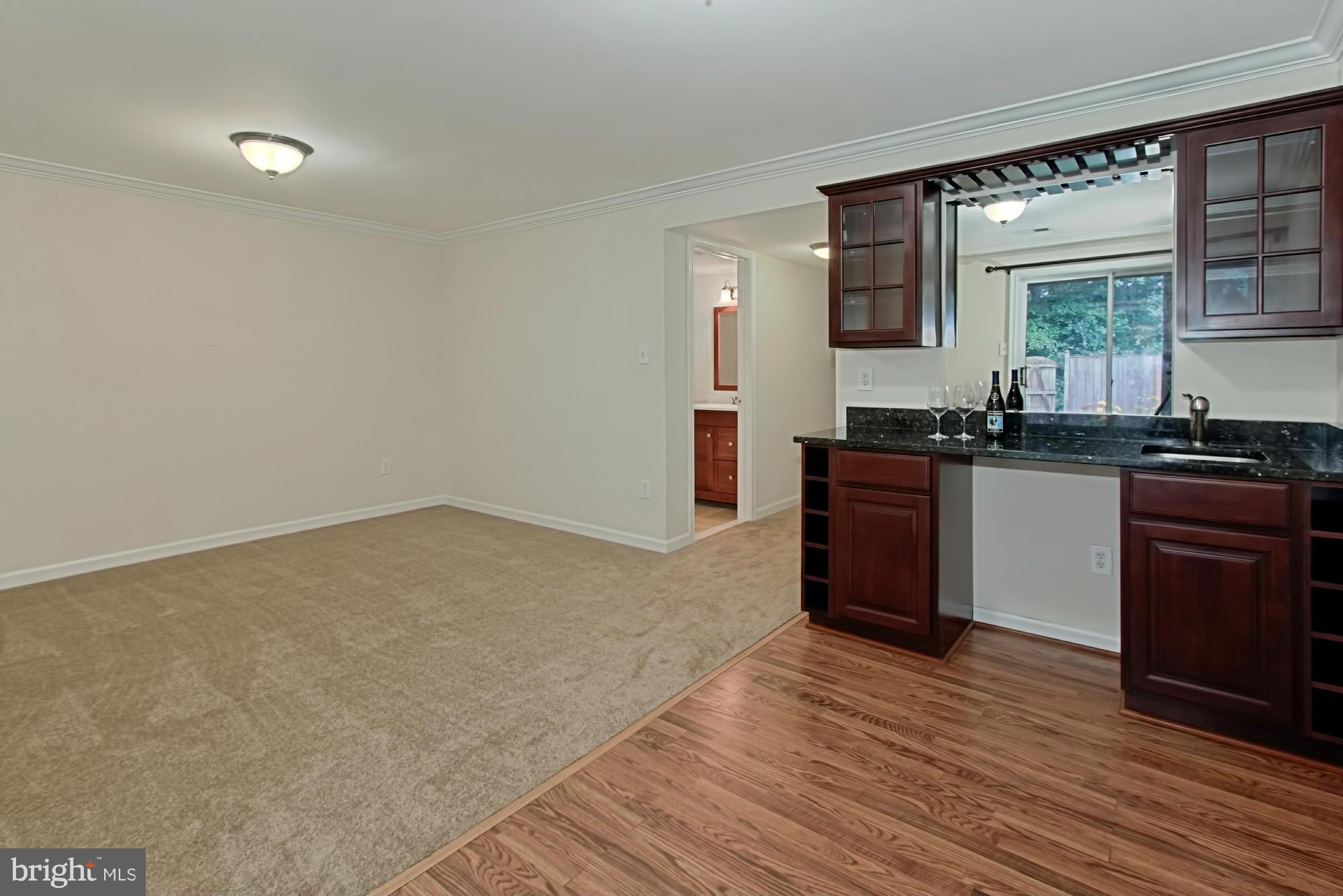 6271 Rathlin Drive Springfield, VA 22152 - Photo 25 of 29 a kitchen with a sink cabinets and wooden floor