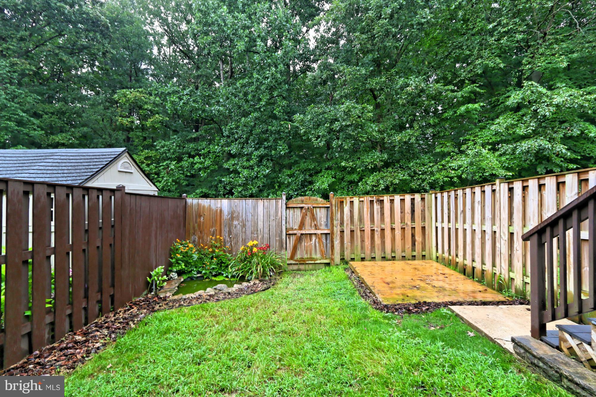 6271 Rathlin Drive Springfield, VA 22152 - Photo 26 of 29 a view of a backyard with a small cabin and wooden fence
