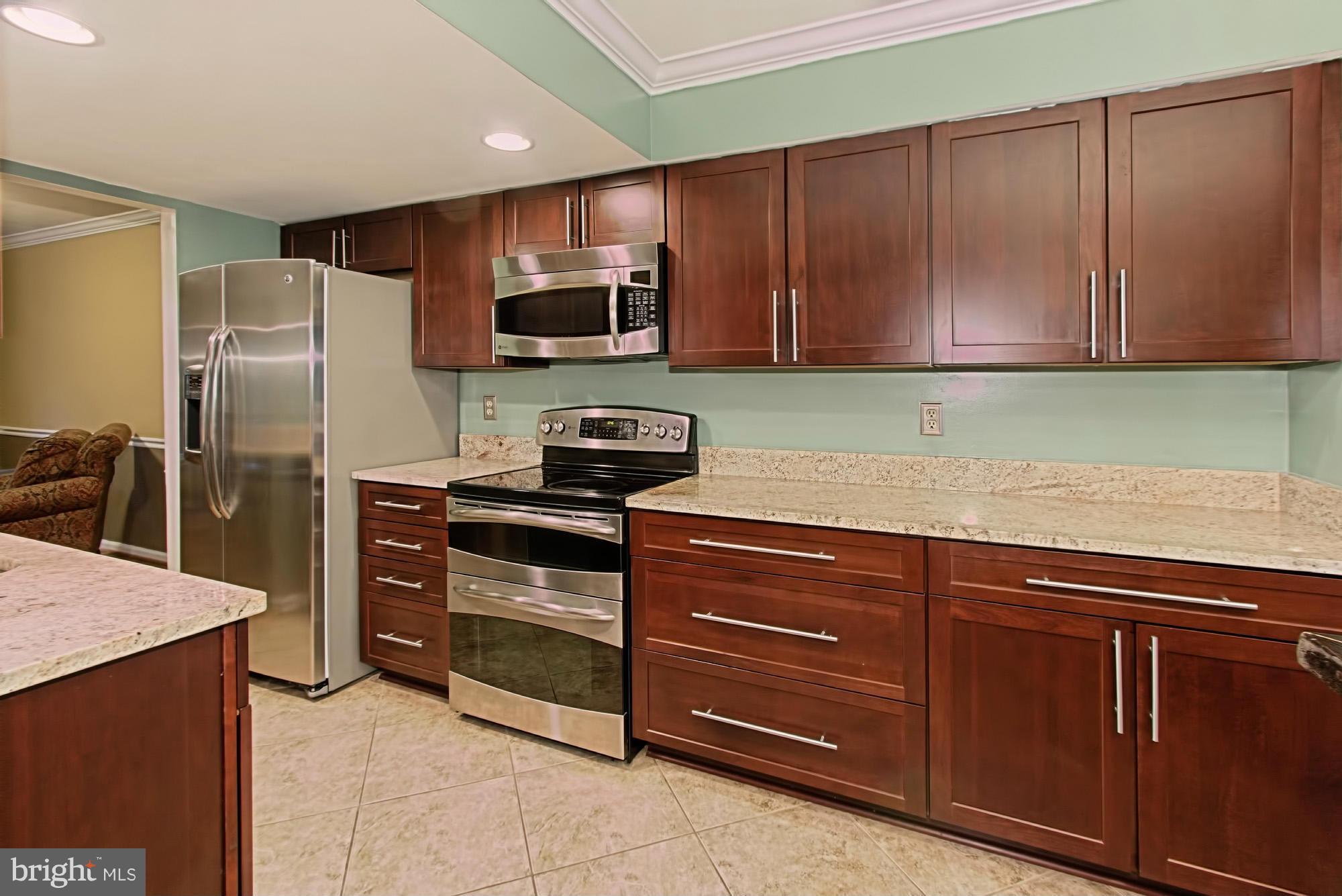 6271 Rathlin Drive Springfield, VA 22152 - Photo 6 of 29 a kitchen with stainless steel appliances granite countertop a refrigerator and cabinets
