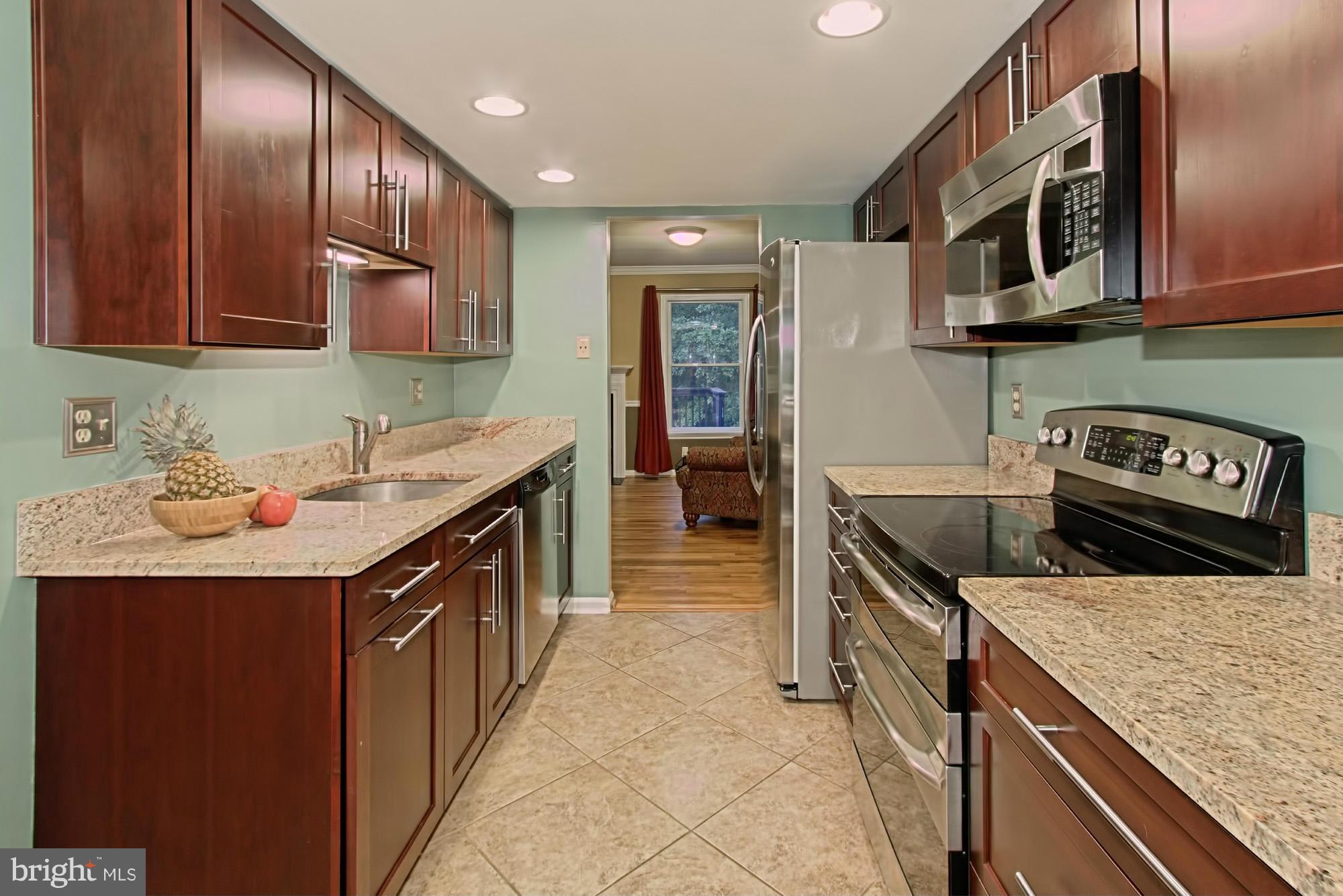 6271 Rathlin Drive Springfield, VA 22152 - Photo 8 of 29 a kitchen with stainless steel appliances granite countertop a sink stove and cabinets