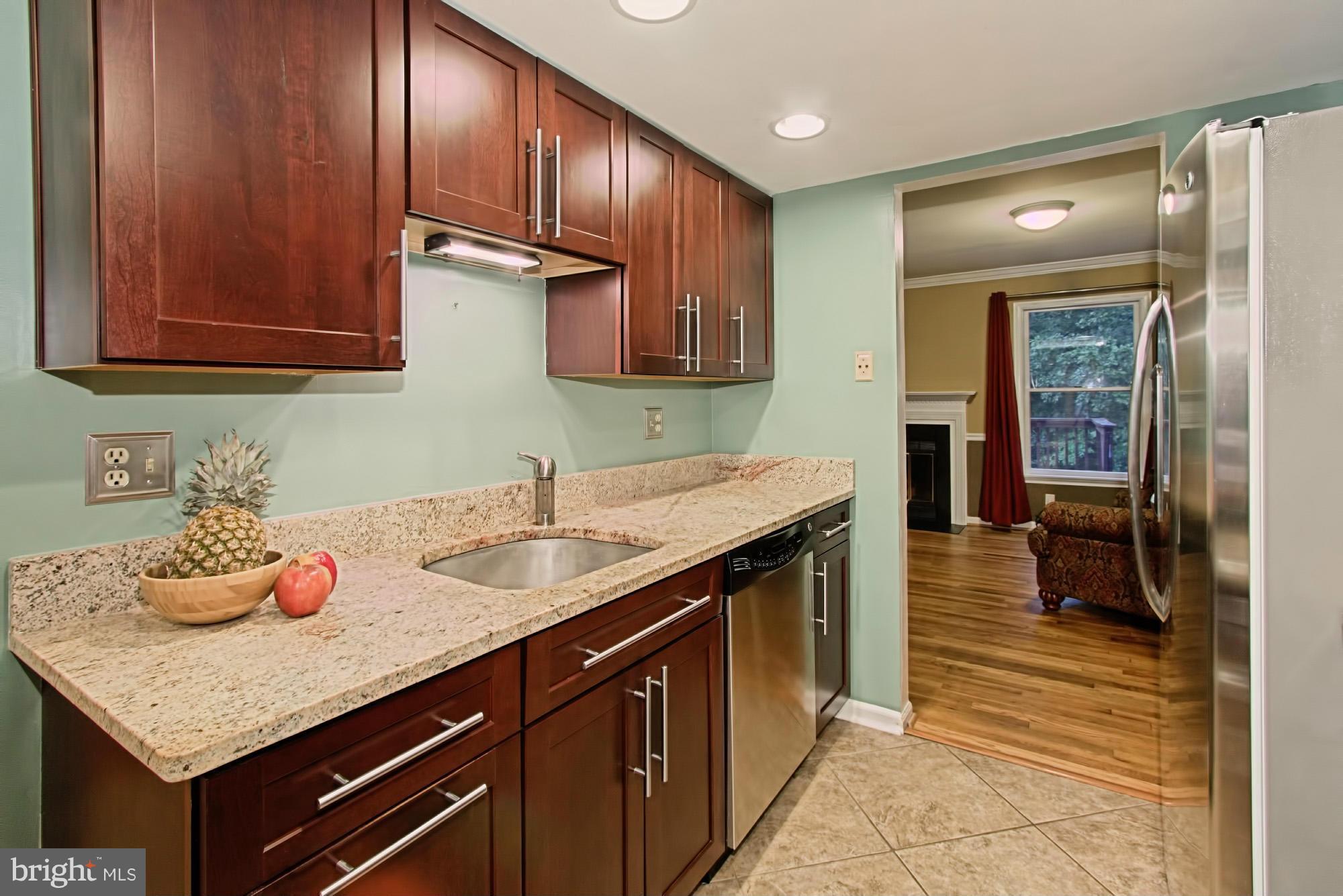 6271 Rathlin Drive Springfield, VA 22152 - Photo 9 of 29 a kitchen with granite countertop stainless steel appliances a sink stove and cabinets