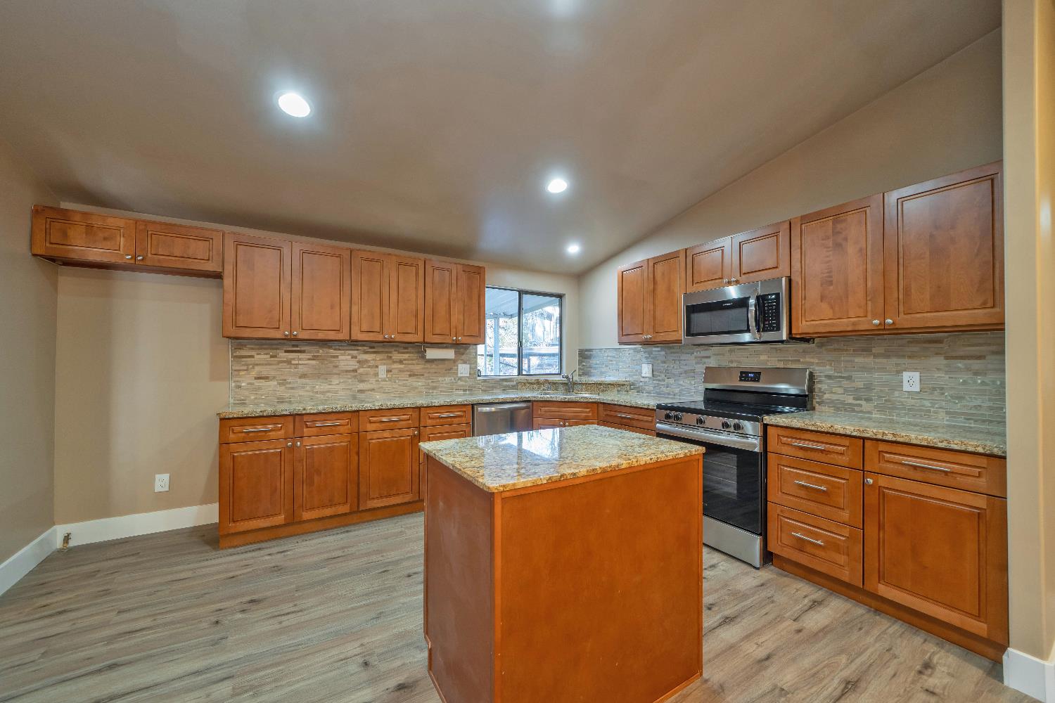 4420 Pleasant Valley Road, Unit 155 Diamond Springs, CA 95619 - Photo 15 of 42 a kitchen with wooden cabinets and stainless steel appliances