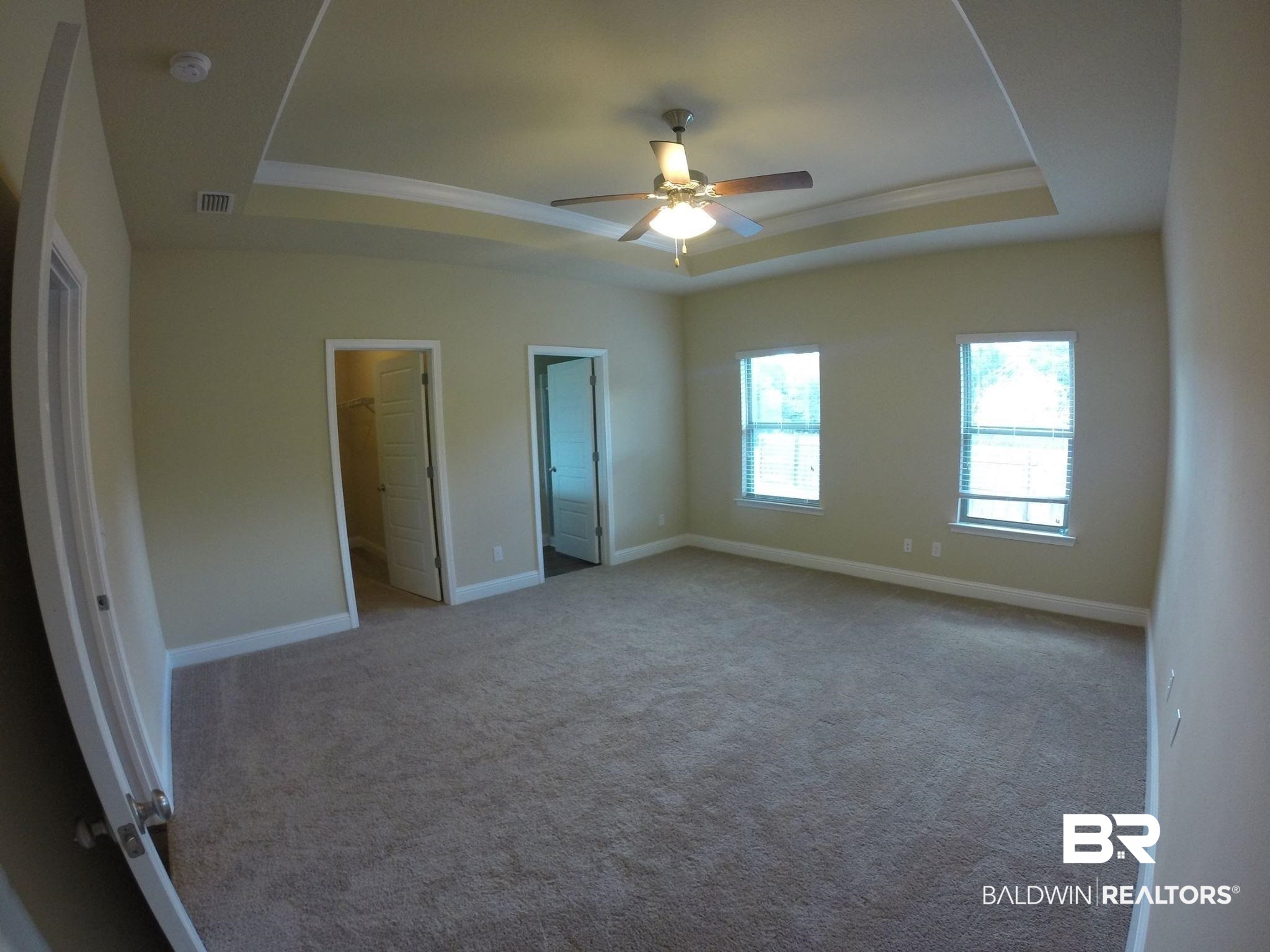 2996 Notsram Court Mobile, AL 36695 - Photo 8 of 16 Unfurnished bedroom with carpet, ornamental molding, baseboards, visible vents, and a raised ceiling