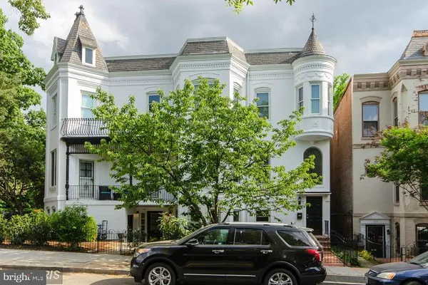 a view of a car parked in front of a brick house
