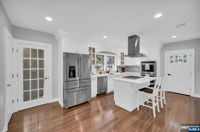 a kitchen with a refrigerator and a stove top oven