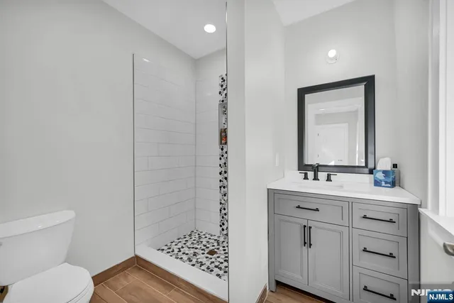 a bathroom with a sink a toilet and shower