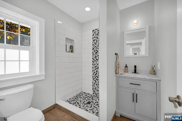 a bathroom with a sink a toilet and window