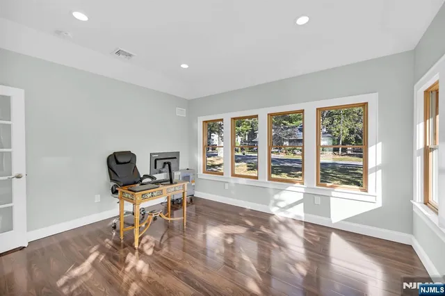a view of a workspace with furniture and a window