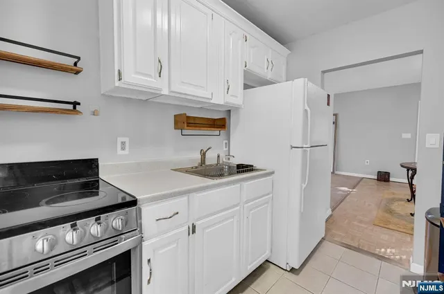 a kitchen with a stove and a refrigerator