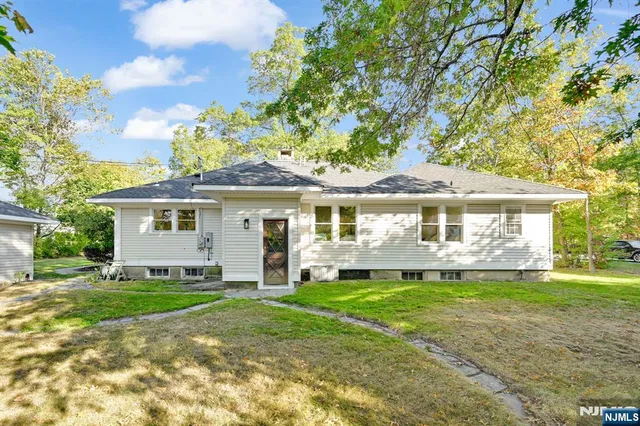 a front view of a house with a yard and porch