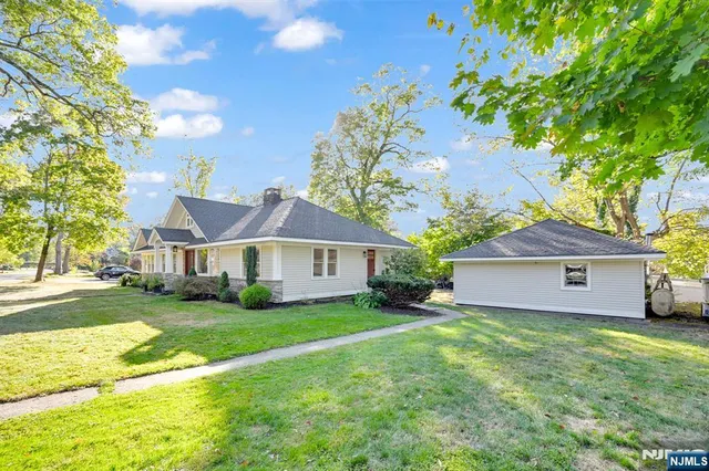 a front view of house with yard and green space
