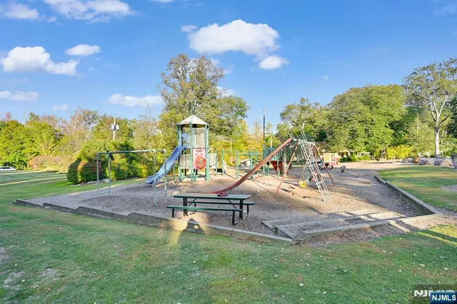 a view of a park with swings and slides