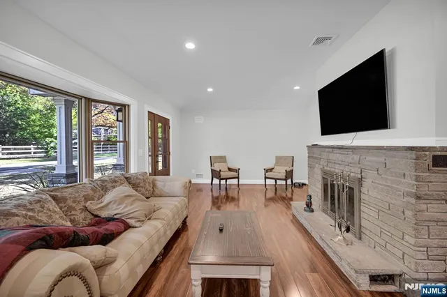 a living room with fireplace furniture and a flat screen tv