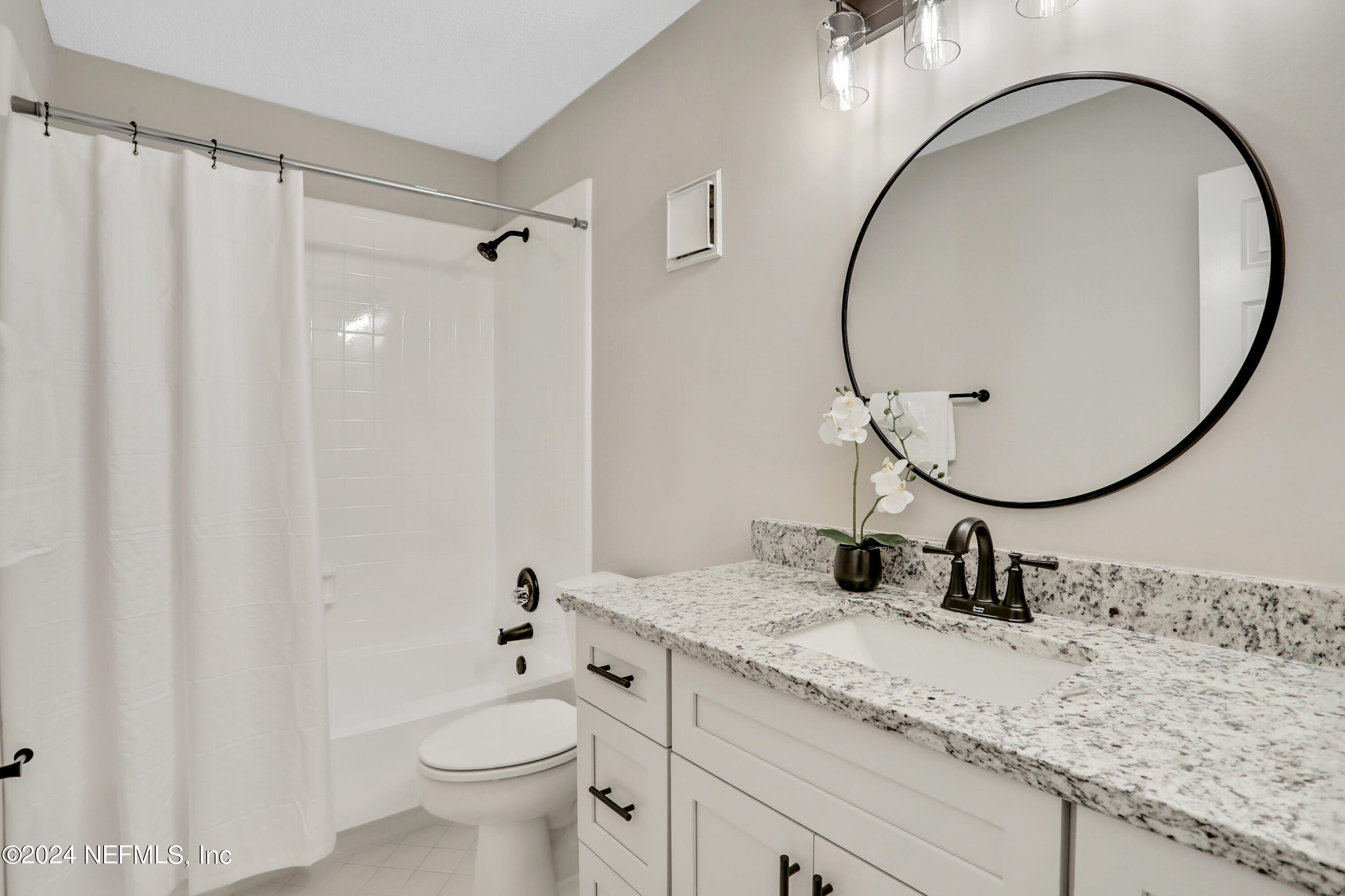 3413 Ricky Court Jacksonville, FL 32223 - Photo 11 of 25 a bathroom with a granite countertop sink toilet and a mirror