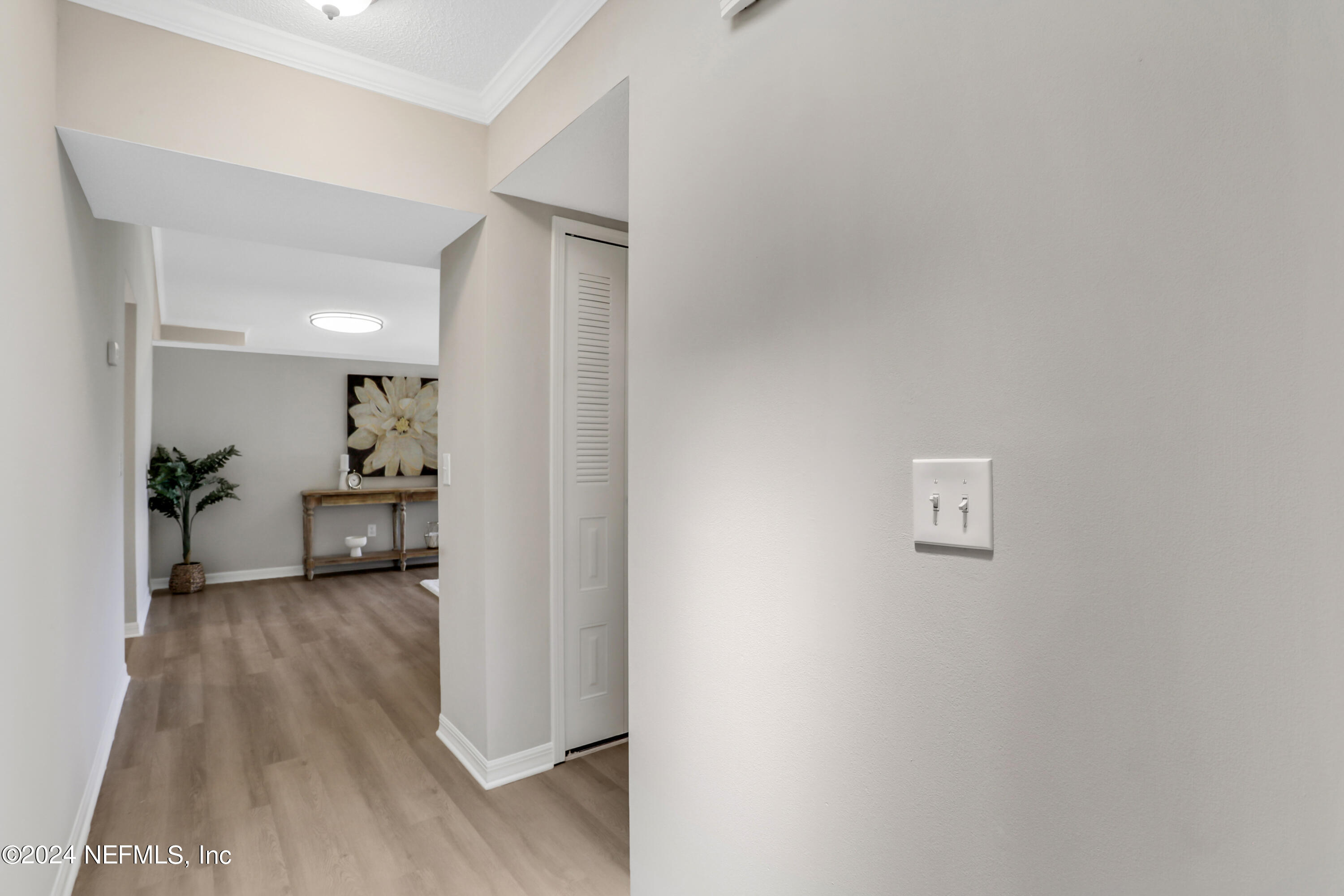 3413 Ricky Court Jacksonville, FL 32223 - Photo 4 of 25 a view of a hallway with wooden floor and a living room