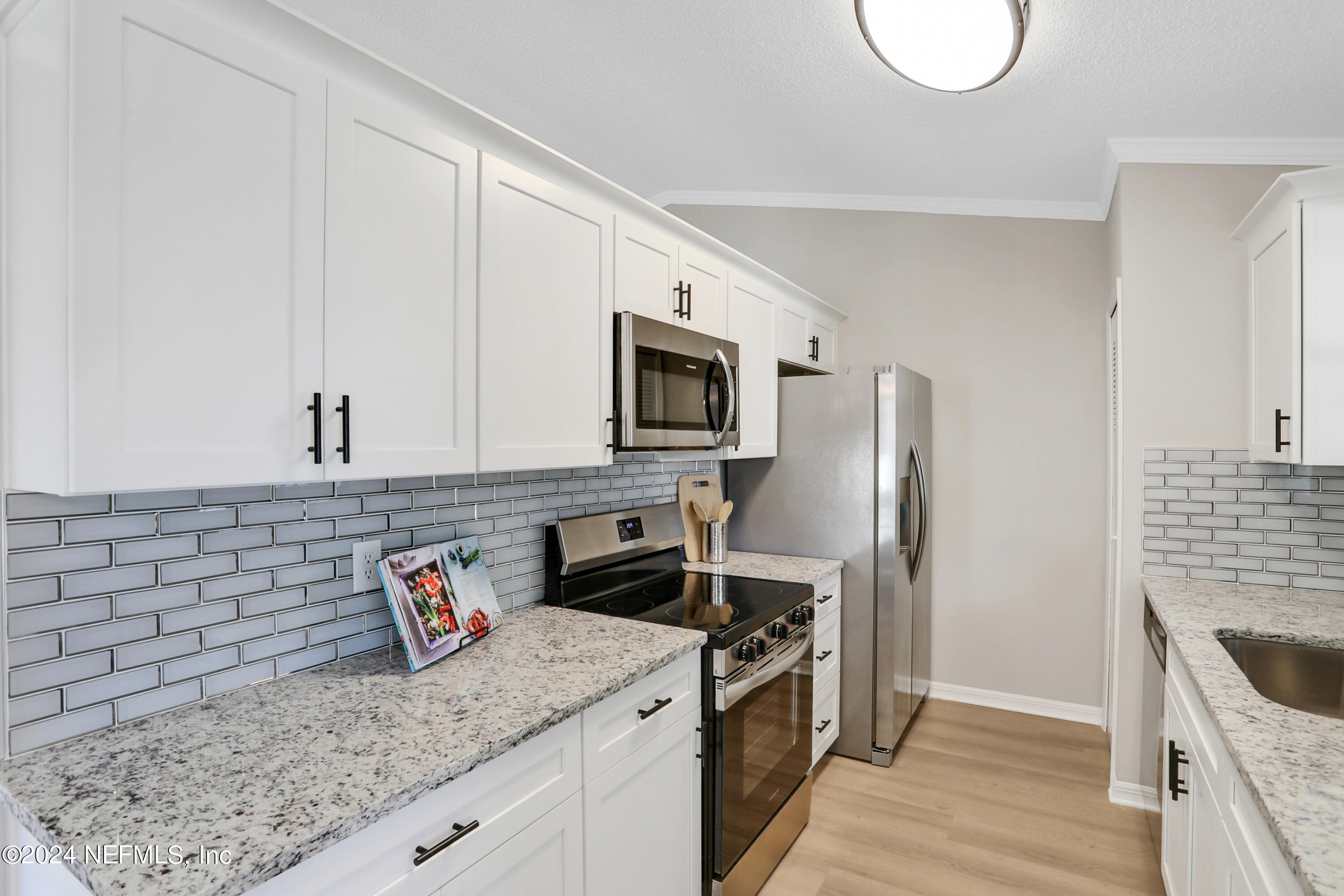 3413 Ricky Court Jacksonville, FL 32223 - Photo 8 of 25 a kitchen with granite countertop a sink a stove and refrigerator