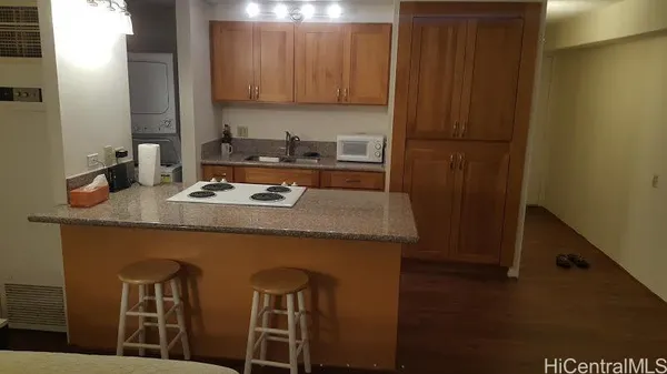 a kitchen with a table chairs and cabinets