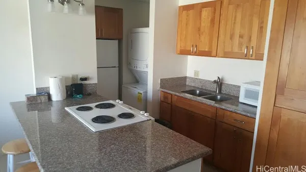 a kitchen with a sink a stove and refrigerator