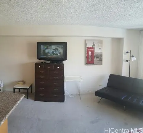 a living room with furniture and a air conditioner vent