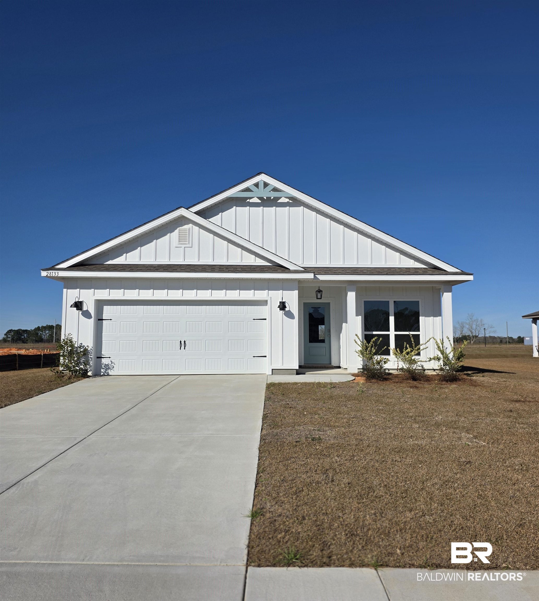 28133 Hallow Trail Elberta, AL 36530 - Photo 1 of 20 View of front of home with board and batten siding, driveway, an attached garage, and a porch