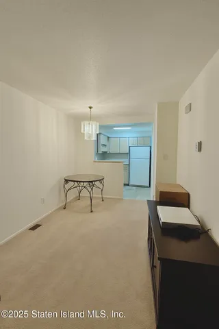 a room with a chair and white walls