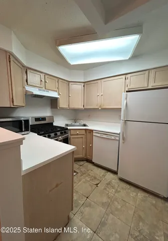 a kitchen with a cabinets and white appliances