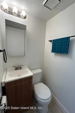 a bathroom with a sink toilet and mirror
