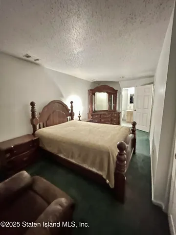 a bedroom with a bed and a night stand