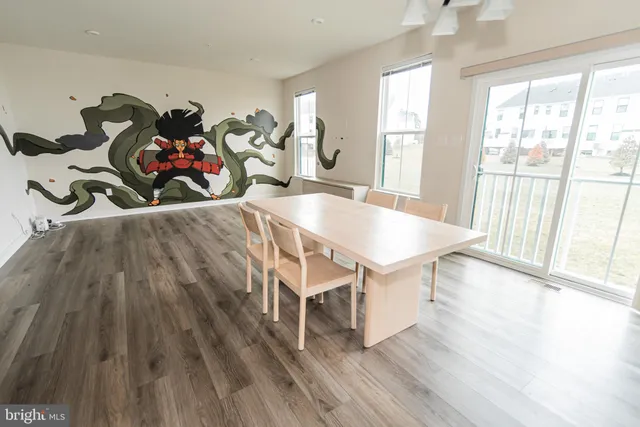 a view of a dining room with furniture wooden floor and chandelier