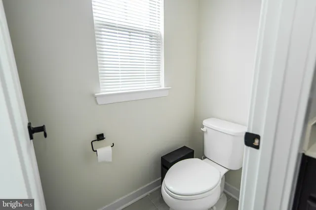 a white toilet sitting next to a bathroom sink