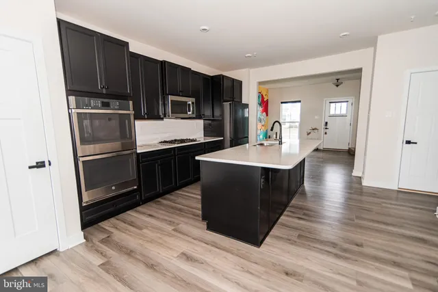 a kitchen with stainless steel appliances a refrigerator and a sink