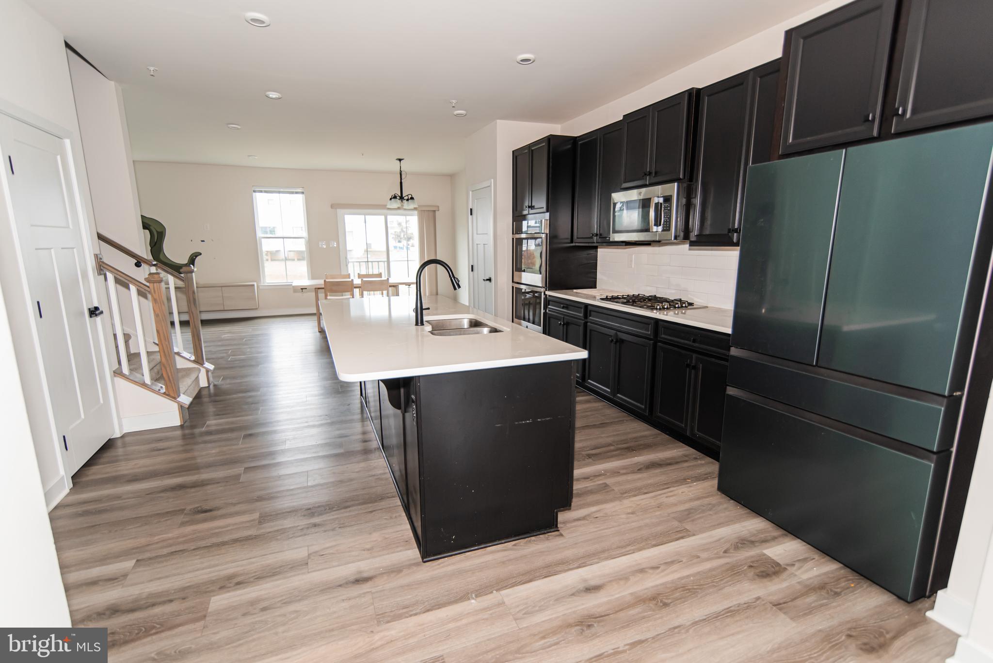 7953 Milltown Circle Cheltenham, PA 19012 - Photo 7 of 24 a kitchen with stainless steel appliances granite countertop a sink a stove a refrigerator and cabinets