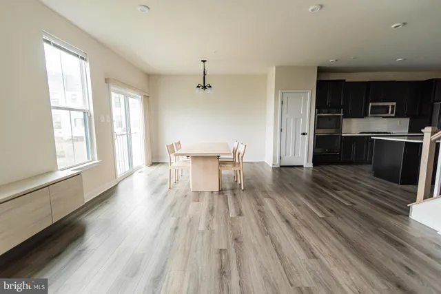a kitchen with wooden floors and wooden cabinets