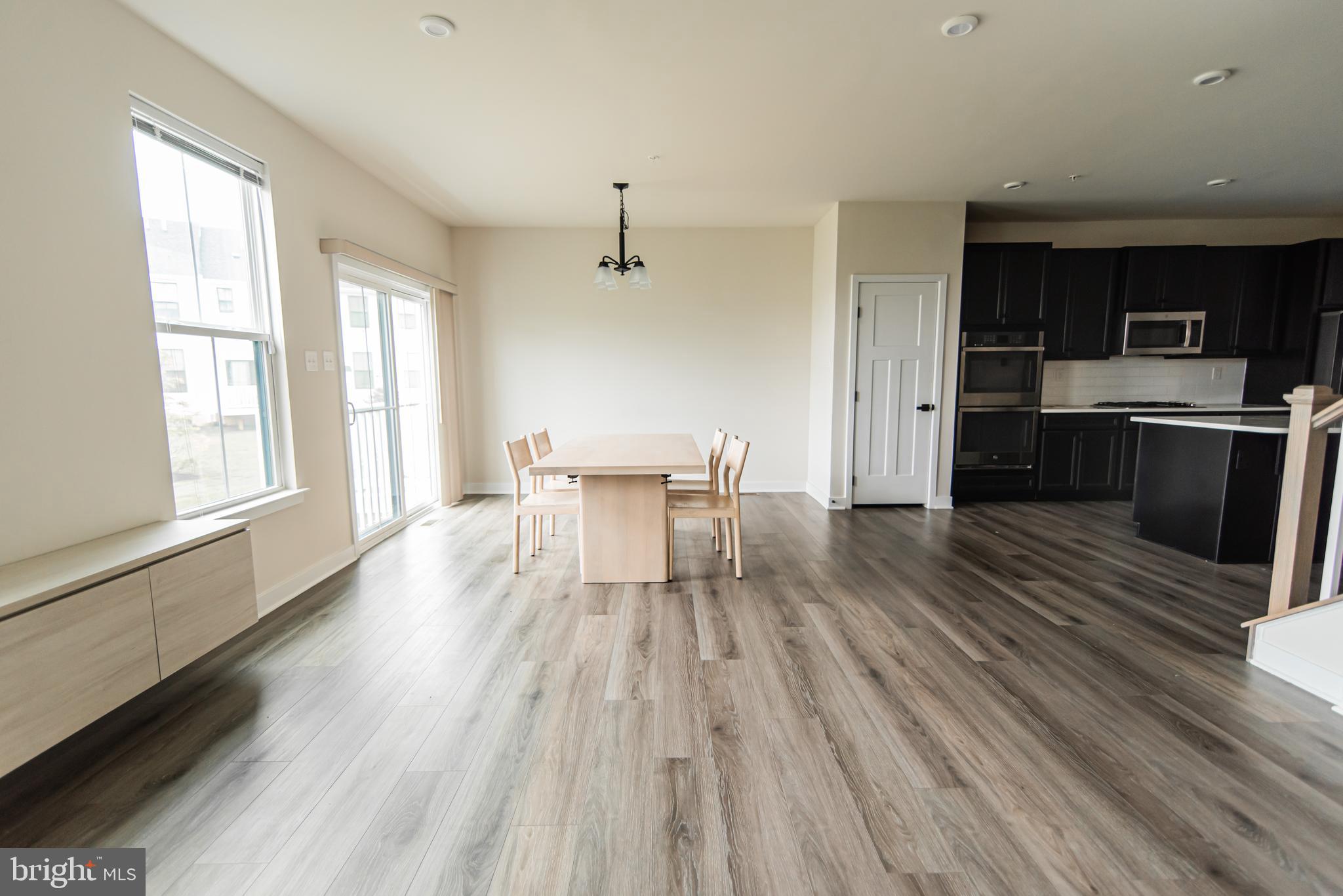 7953 Milltown Circle Cheltenham, PA 19012 - Photo 10 of 24 a kitchen with wooden floors and wooden cabinets